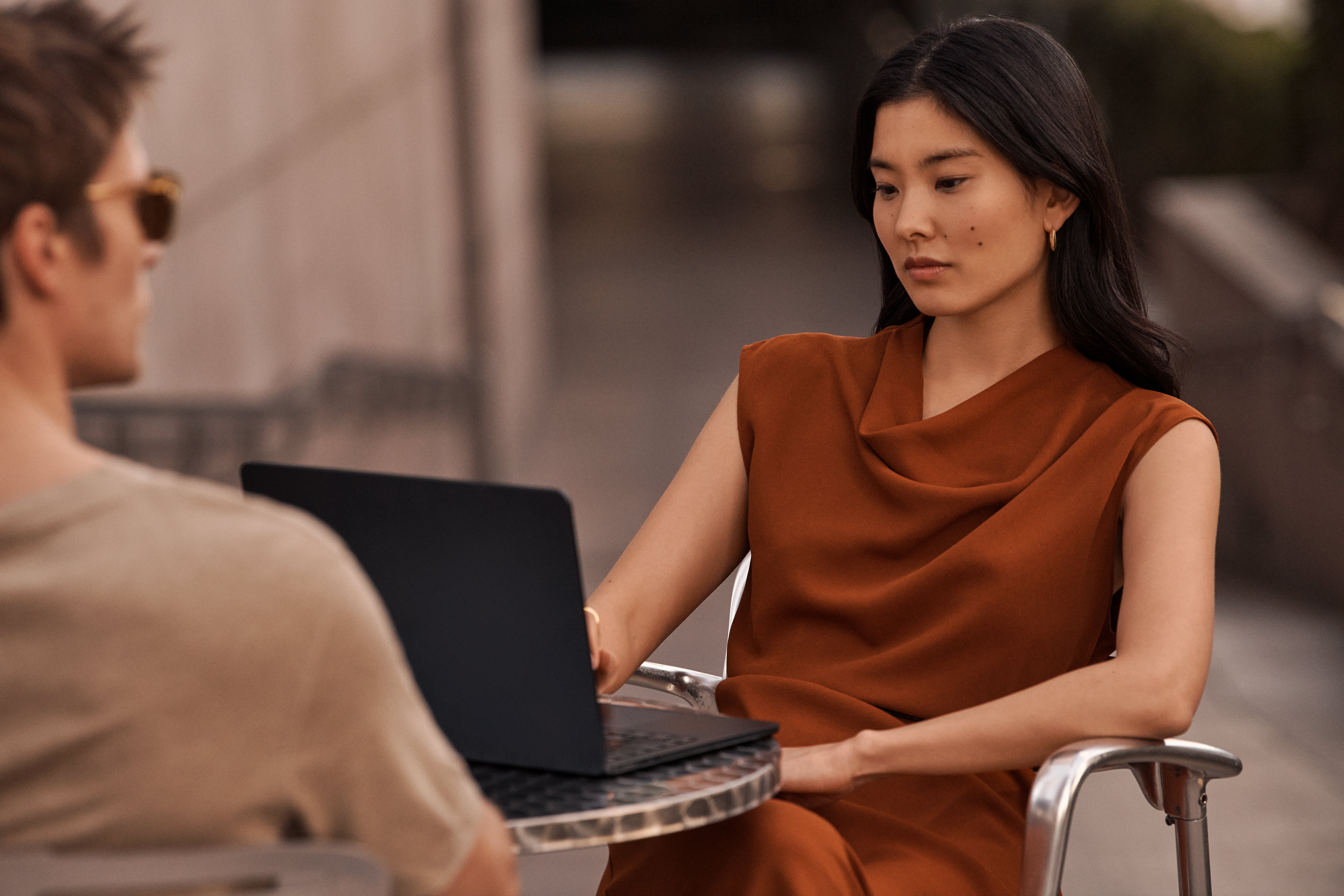 Woman and Man at cafe table with laptop