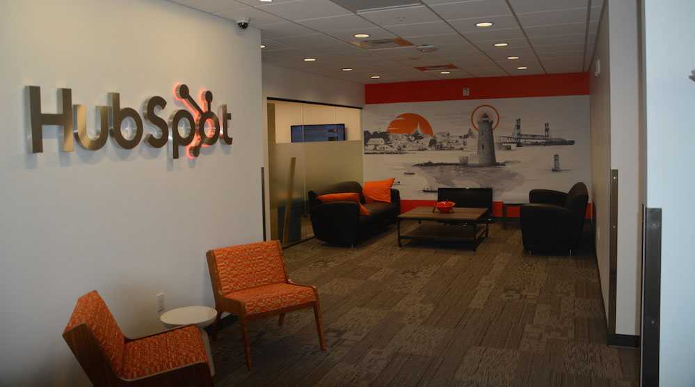 Orange mural that says 'ship it's on a wall at HubSpot's Singapore office